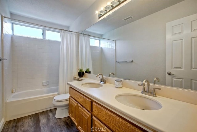 32197 Callesito Fadrique, Temecula, CA 92592 - bathroom featuring shower / bath combination with curtain, plenty of natural light, wood finished floors, and double vanity