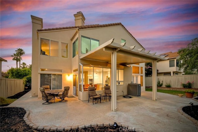 32197 Callesito Fadrique, Temecula, CA 92592 - back of property at dusk with a chimney, a patio, stucco siding, and a tile roof