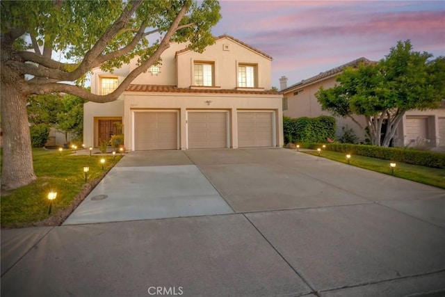 32197 Callesito Fadrique, Temecula, CA 92592 - mediterranean / spanish home with driveway, a garage, stucco siding, a lawn, and a tile roof