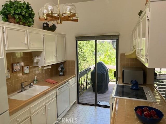 27821 Peninsula Dr, Lake Arrowhead, CA 92352 - kitchen featuring white appliances, white cabinets, tasteful backsplash, and a chandelier