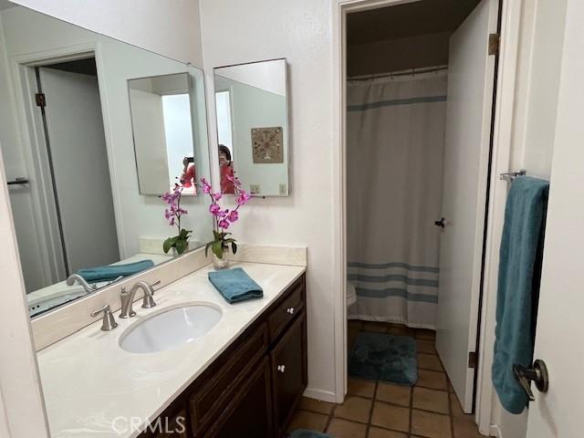 27821 Peninsula Dr, Lake Arrowhead, CA 92352 - full bath with vanity, tile patterned floors, and a shower with curtain