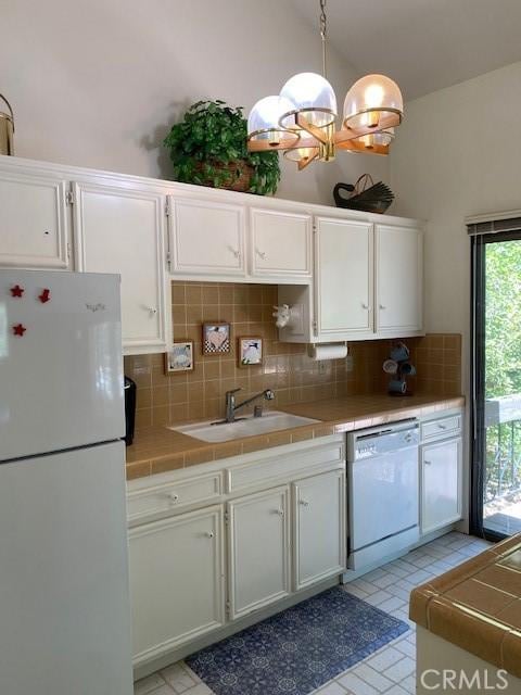 27821 Peninsula Dr, Lake Arrowhead, CA 92352 - kitchen with white appliances, tile counters, decorative backsplash, white cabinetry, and vaulted ceiling