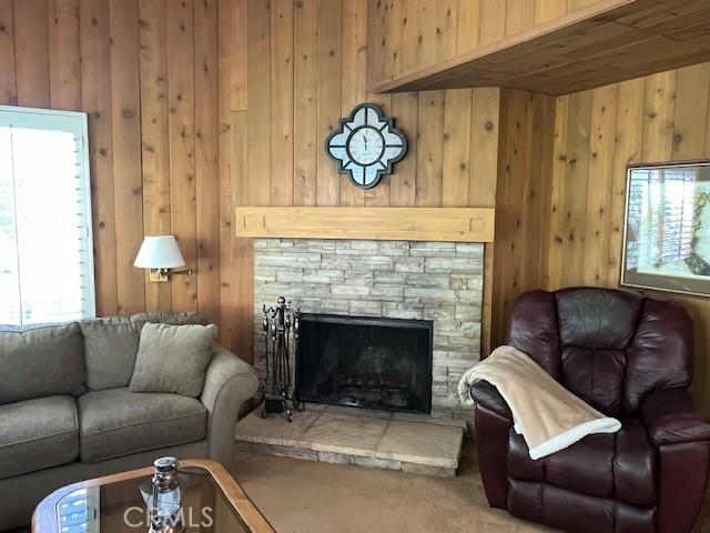 27821 Peninsula Dr, Lake Arrowhead, CA 92352 - living area featuring wood walls, a fireplace, and carpet