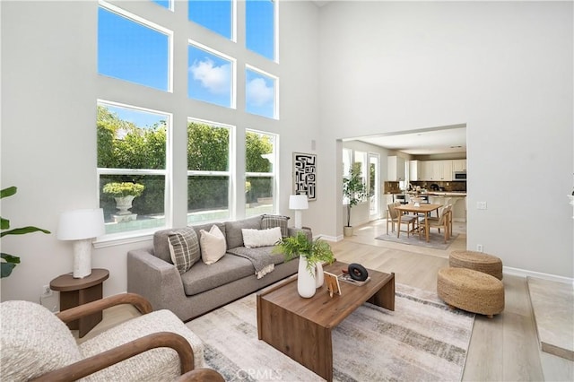 29125 Starwood Pl, Saugus, CA 91390 - living room featuring light wood-type flooring and a towering ceiling