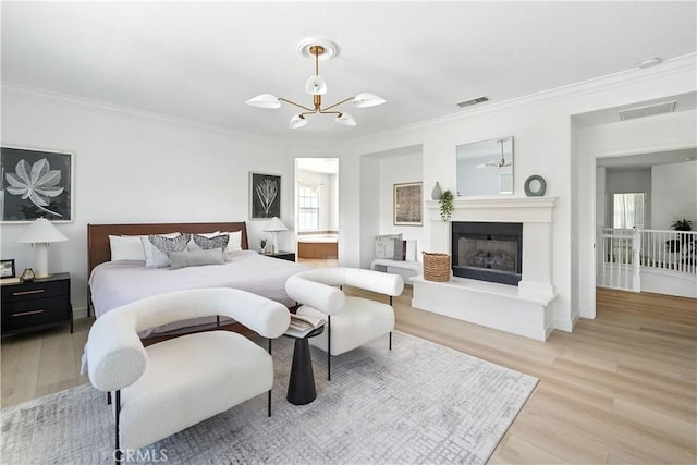 29125 Starwood Pl, Saugus, CA 91390 - bedroom with ornamental molding, light wood-style floors, a chandelier, and a fireplace with raised hearth