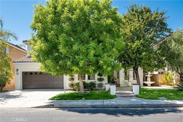 29125 Starwood Pl, Saugus, CA 91390 - obstructed view of property featuring a garage, driveway, a tile roof, and stucco siding