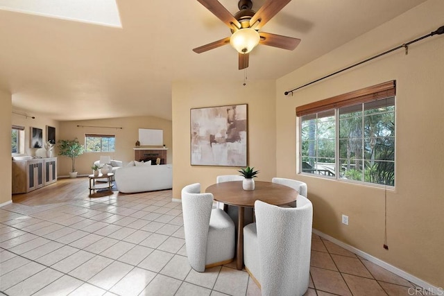 1153 Merritt Dr, El Cajon, CA 92020 - dining room featuring light tile patterned flooring, healthy amount of natural light, a ceiling fan, and a brick fireplace