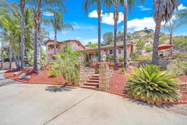 1153 Merritt Dr, El Cajon, CA 92020 - mediterranean / spanish-style house with stucco siding, a tiled roof, and stairway