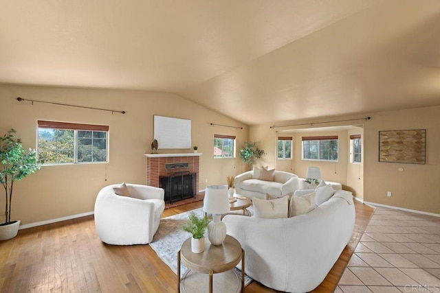 1153 Merritt Dr, El Cajon, CA 92020 - living room with hardwood / wood-style floors, vaulted ceiling, and a fireplace