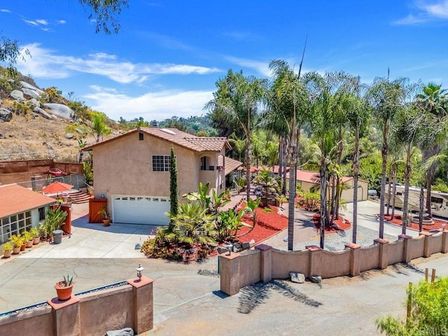 1153 Merritt Dr, El Cajon, CA 92020 - view of property exterior featuring stucco siding, a garage, concrete driveway, and a tile roof