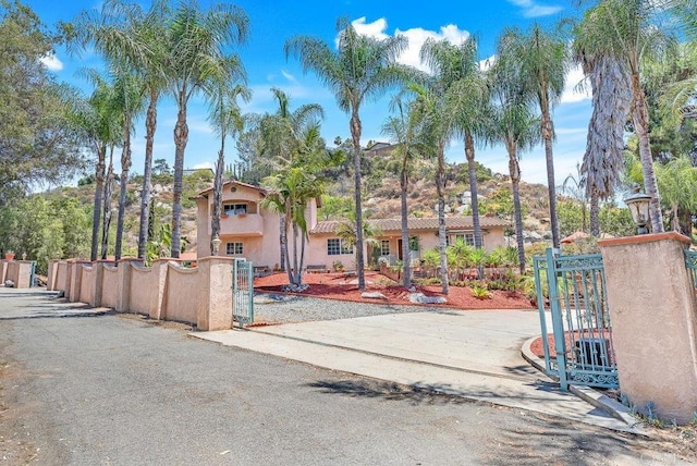 1153 Merritt Dr, El Cajon, CA 92020 - view of front of property with a gate, stucco siding, and a fenced front yard