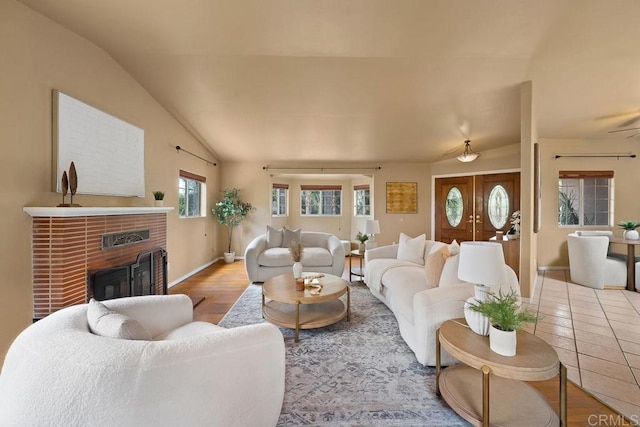 1153 Merritt Dr, El Cajon, CA 92020 - living area featuring a fireplace, lofted ceiling, and wood finished floors