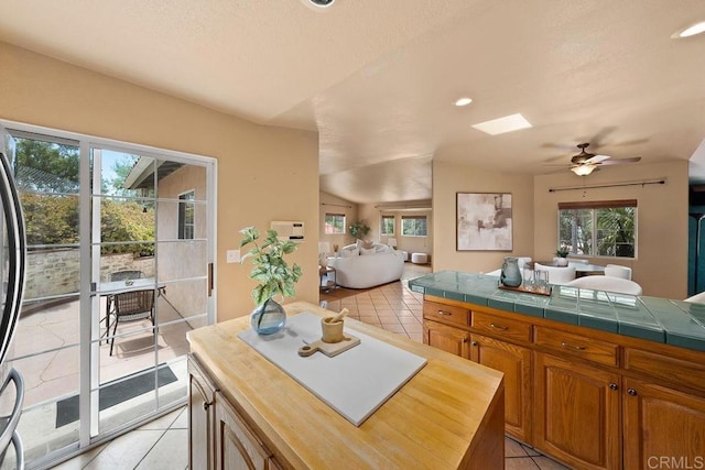 1153 Merritt Dr, El Cajon, CA 92020 - kitchen featuring light tile patterned floors, open floor plan, ceiling fan, recessed lighting, and wood counters