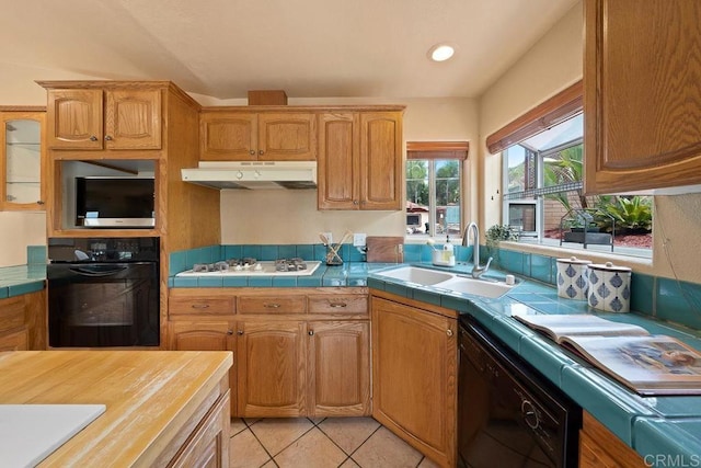 1153 Merritt Dr, El Cajon, CA 92020 - kitchen featuring black appliances, under cabinet range hood, tile countertops, light tile patterned flooring, and recessed lighting