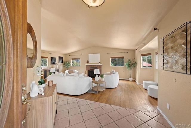 1153 Merritt Dr, El Cajon, CA 92020 - tiled living room with vaulted ceiling and a fireplace