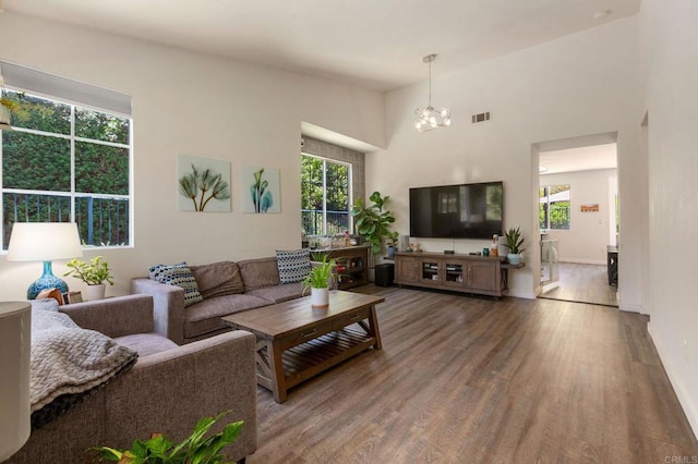 888 Arvita Ct, Oceanside, CA 92057 - living room featuring wood finished floors, a chandelier, and a towering ceiling