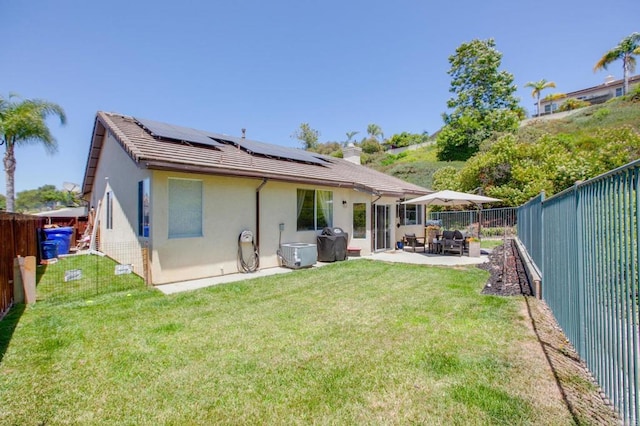 888 Arvita Ct, Oceanside, CA 92057 - rear view of property featuring a fenced backyard, solar panels, stucco siding, a tiled roof, and a patio area