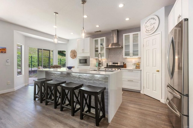 888 Arvita Ct, Oceanside, CA 92057 - kitchen featuring stainless steel appliances, wall chimney range hood, recessed lighting, tasteful backsplash, and dark wood-style floors