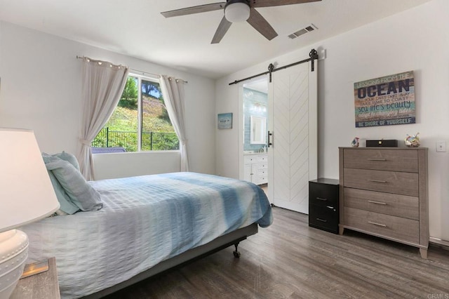 888 Arvita Ct, Oceanside, CA 92057 - bedroom with dark wood-style flooring, a barn door, a ceiling fan, and ensuite bathroom