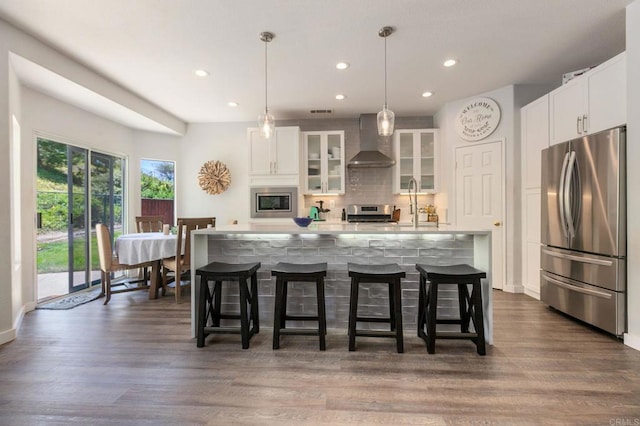 888 Arvita Ct, Oceanside, CA 92057 - kitchen featuring stainless steel appliances, wall chimney exhaust hood, recessed lighting, tasteful backsplash, and a center island with sink