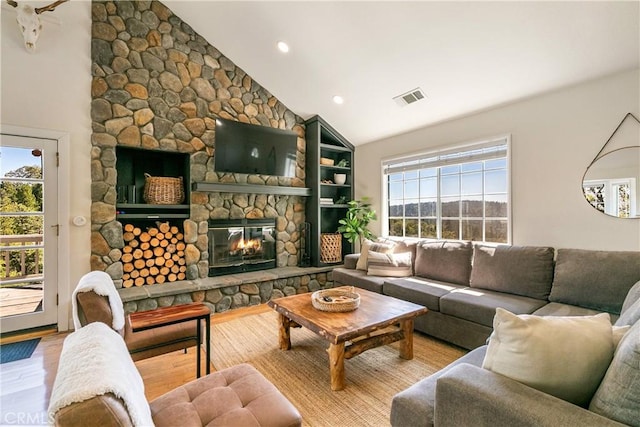 915 Breithorn Dr, Lake Arrowhead, CA 92352 - living room featuring healthy amount of natural light, a stone fireplace, wood finished floors, high vaulted ceiling, and recessed lighting