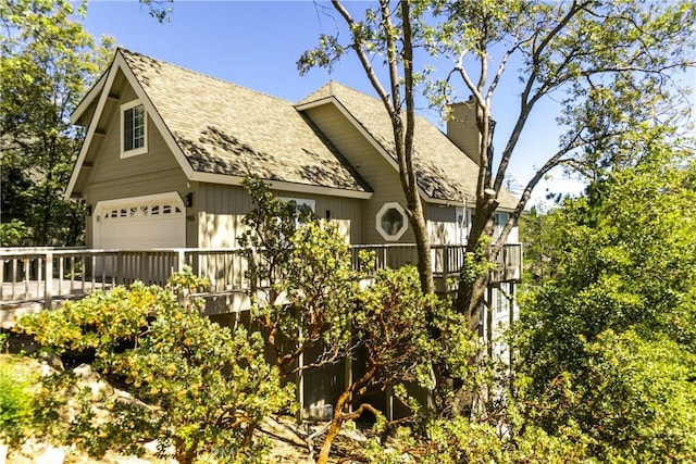 915 Breithorn Dr, Lake Arrowhead, CA 92352 - view of property exterior featuring a garage, a chimney, a shingled roof, and a deck