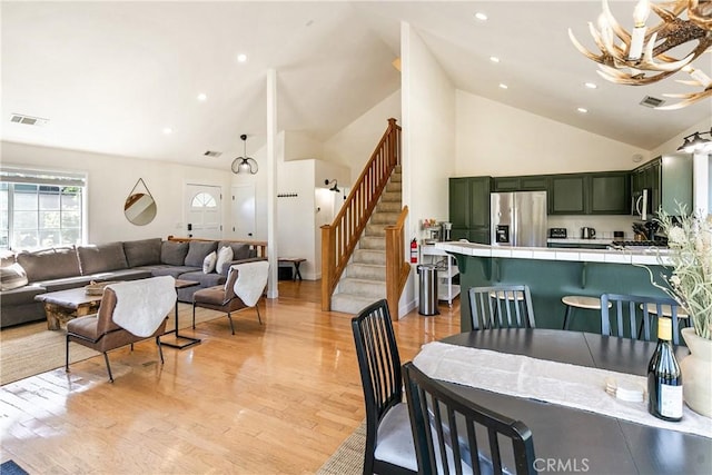 915 Breithorn Dr, Lake Arrowhead, CA 92352 - dining space featuring high vaulted ceiling, light wood-style flooring, stairs, and recessed lighting