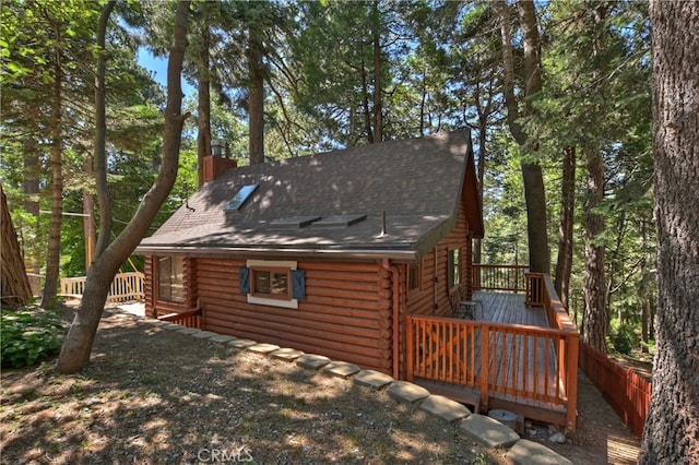 788 Buckingham Sq, Lake Arrowhead, CA 92352 - back of property with log siding, a deck, a chimney, and a shingled roof