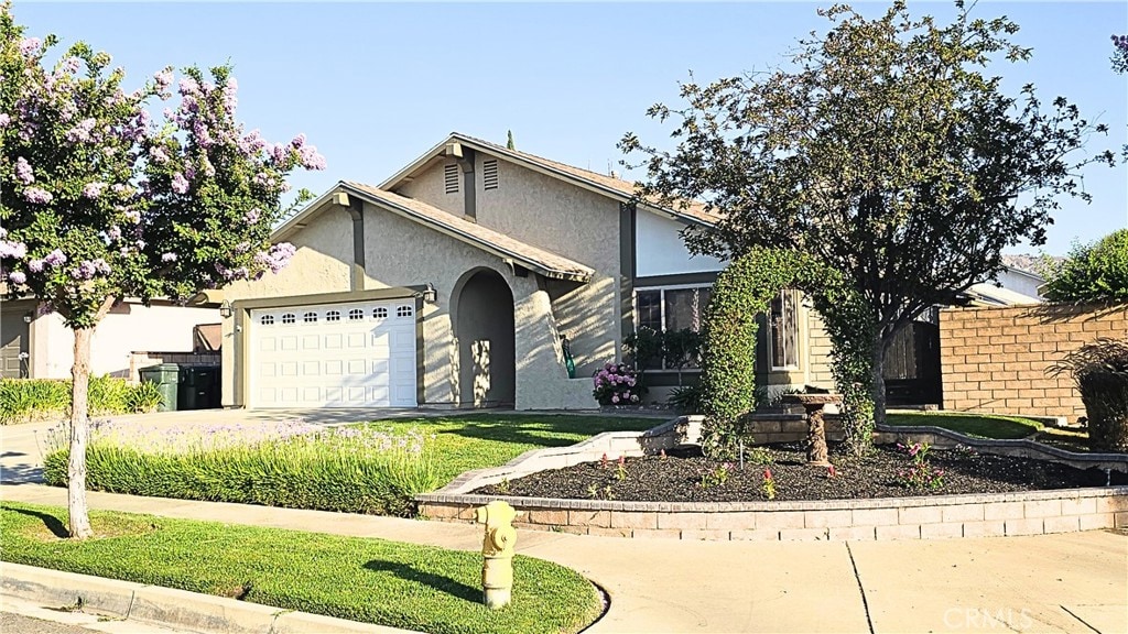 22361 Raven Way, Grand Terrace, CA 92313 - view of front of house featuring a garage, stucco siding, and concrete driveway