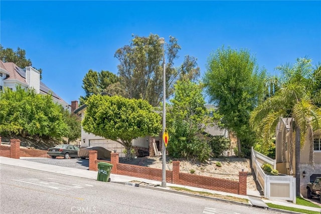 11922 Louise Ave, Granada Hills, CA 91344 - view of property hidden behind natural elements with a garage and stucco siding