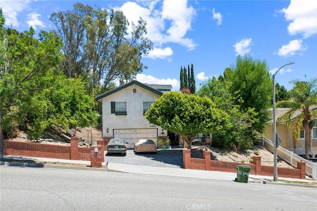 11922 Louise Ave, Granada Hills, CA 91344 - view of front of property featuring a garage, driveway, and stucco siding