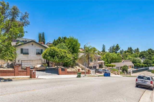 11922 Louise Ave, Granada Hills, CA 91344 - view of front facade featuring a garage and stucco siding