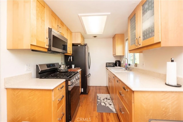 9228 Elm Vista Dr Unit B, Downey, CA 90242 - kitchen with stainless steel appliances, light wood finished floors, light countertops, and glass insert cabinets