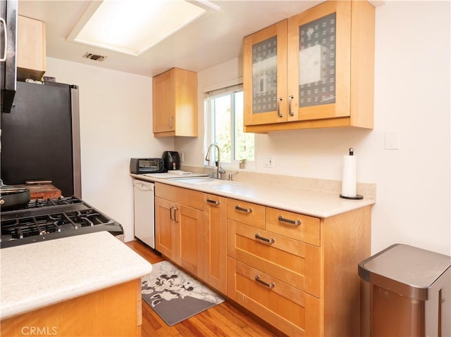 9228 Elm Vista Dr Unit B, Downey, CA 90242 - kitchen featuring freestanding refrigerator, dishwasher, light wood finished floors, light countertops, and range