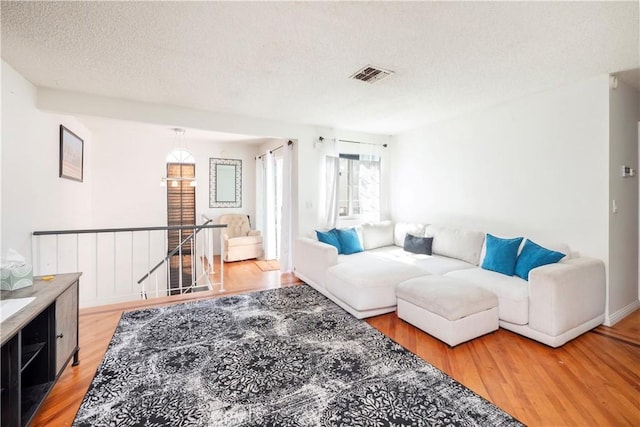 9228 Elm Vista Dr Unit B, Downey, CA 90242 - living area with light wood-style floors and a textured ceiling