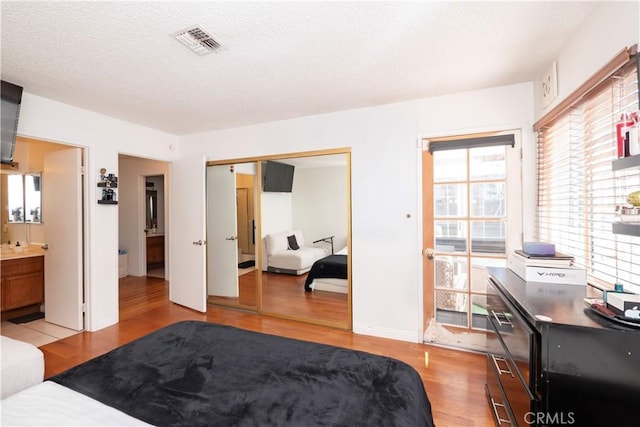 9228 Elm Vista Dr Unit B, Downey, CA 90242 - bedroom with light wood-type flooring, a closet, and a textured ceiling
