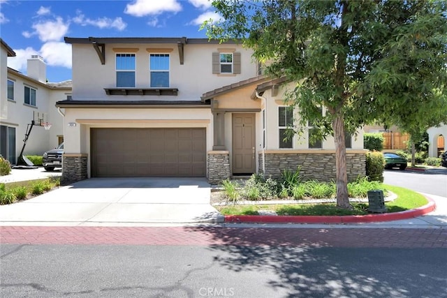 434 Sonora Cir, Redlands, CA 92373 - view of front of house featuring stone siding, concrete driveway, stucco siding, and an attached garage