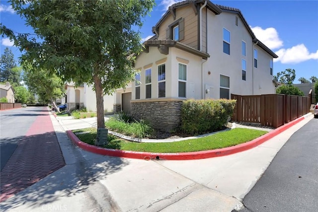 434 Sonora Cir, Redlands, CA 92373 - view of side of home featuring stone siding and stucco siding