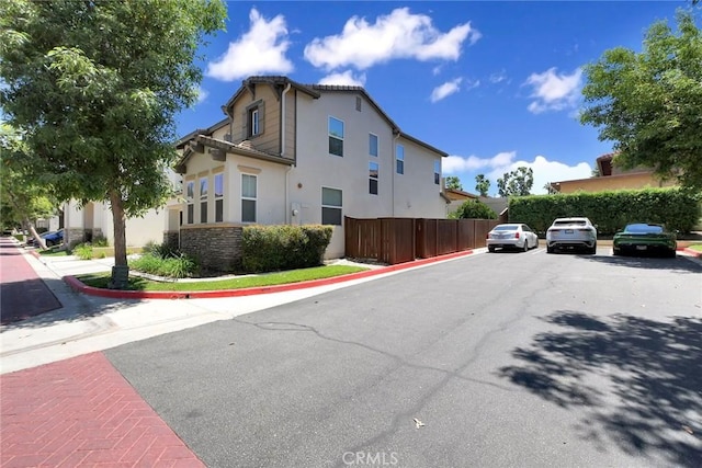 434 Sonora Cir, Redlands, CA 92373 - view of side of property with stucco siding and uncovered parking