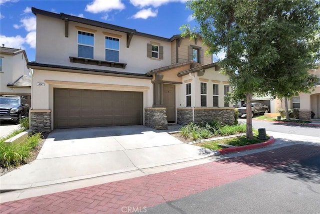 434 Sonora Cir, Redlands, CA 92373 - view of front facade featuring stone siding, driveway, stucco siding, and a garage