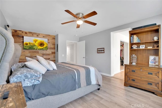 434 Sonora Cir, Redlands, CA 92373 - bedroom with wood walls, light wood-type flooring, an accent wall, and ceiling fan