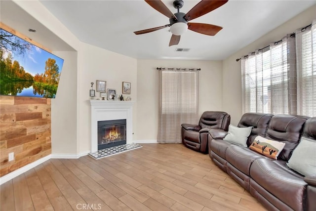 434 Sonora Cir, Redlands, CA 92373 - living area featuring a ceiling fan, light wood-style flooring, and a glass covered fireplace