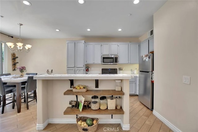 434 Sonora Cir, Redlands, CA 92373 - kitchen with appliances with stainless steel finishes, tile countertops, open shelves, a chandelier, and light wood-type flooring