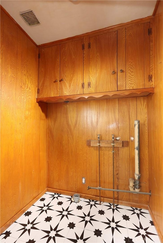8220 Owens St, Sunland, CA 91040 - laundry area with light floors, cabinet space, and wooden walls