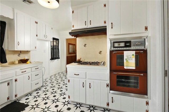 8220 Owens St, Sunland, CA 91040 - kitchen featuring multiple ovens, gas cooktop, light flooring, light countertops, and backsplash