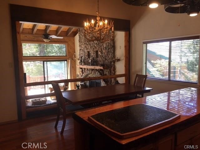 847 Tehama Dr, Big Bear Lake, CA 92315 - dining area with a chandelier, healthy amount of natural light, beam ceiling, and dark wood-style flooring