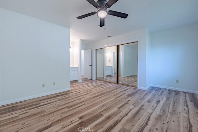 2950 Marie Ln, Merced, CA 95340 - unfurnished bedroom featuring light wood-style floors, a closet, and a ceiling fan