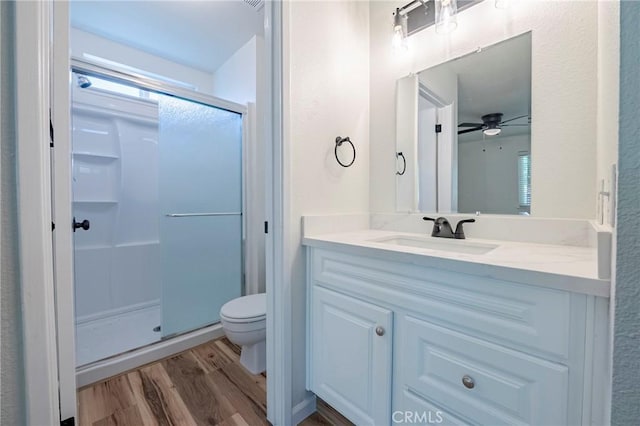 2950 Marie Ln, Merced, CA 95340 - full bathroom with a stall shower, wood finished floors, vanity, and ceiling fan