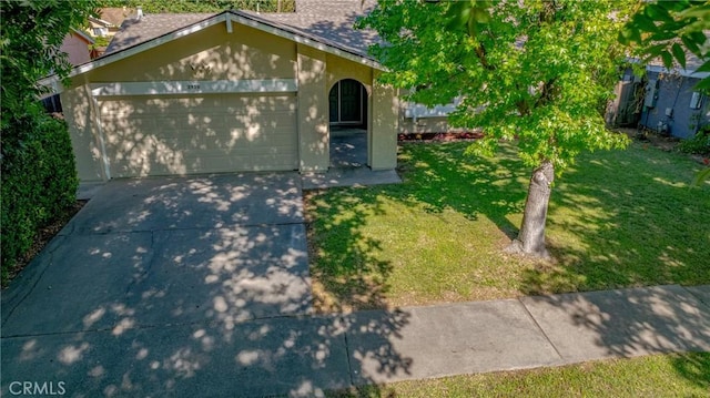 2950 Marie Ln, Merced, CA 95340 - view of front of home with a front yard, driveway, stucco siding, and an attached garage