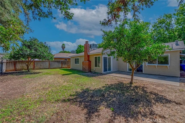 2950 Marie Ln, Merced, CA 95340 - rear view of property with a fenced backyard, a chimney, a patio area, and stucco siding